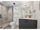 Modern bathroom featuring a tiled shower with glass door, gray vanity, and white countertop at 1236 N Tennyson St, Denver, CO 80204