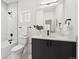 Modern bathroom featuring a sleek vanity, marble-tiled shower, and an abundance of natural light at 1236 N Tennyson St, Denver, CO 80204