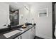 Modern bathroom with a double vanity, a sleek black countertop, and elegant marble accents for a luxurious feel at 1236 N Tennyson St, Denver, CO 80204