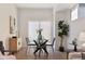 Bright dining area featuring a glass table, modern chairs, and a sliding glass door for plenty of natural light at 1236 N Tennyson St, Denver, CO 80204