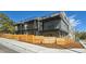 Modern townhome exterior featuring multiple balconies, a fence, and stylish architecture at 1236 N Tennyson St, Denver, CO 80204