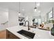 Open-concept kitchen featuring a breakfast bar and an adjacent living room area with a fireplace at 1236 N Tennyson St, Denver, CO 80204