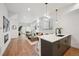 Open-concept living room with hardwood floors and modern fixtures adjacent to a sleek kitchen with a breakfast bar at 1236 N Tennyson St, Denver, CO 80204