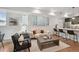 Bright living room featuring stylish furniture, wood floors, and open layout to the kitchen at 1236 N Tennyson St, Denver, CO 80204