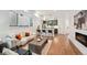 Comfortable living room with bar seating, a modern fireplace, and an adjacent kitchen area with stainless steel appliances at 1236 N Tennyson St, Denver, CO 80204