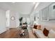 Inviting living room featuring hardwood floors, contemporary furniture, and large windows with access to an outdoor patio at 1236 N Tennyson St, Denver, CO 80204