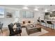 Cozy living room with stylish seating, a modern fireplace, and an adjacent kitchen area with bar seating at 1236 N Tennyson St, Denver, CO 80204