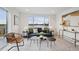 Bright living room featuring modern decor, plush seating, and a large window with city views at 1236 N Tennyson St, Denver, CO 80204