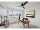 Bright home office featuring a modern ceiling fan, large window, and stylish wood desk perfect for work and study at 1236 N Tennyson St, Denver, CO 80204