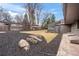 Backyard featuring mulch, mature trees, a well manicured lawn, and a modern patio at 456 Cherry St, Denver, CO 80220