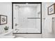 Updated bathroom featuring a glass enclosed shower with a bronze rainfall showerhead and bright tile at 456 Cherry St, Denver, CO 80220