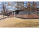 Mid-century home with brick exterior, modern landscaping, and a well maintained front yard at 456 Cherry St, Denver, CO 80220