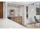 Stylish kitchen has stainless steel drink cooler with stylish gray backsplash and hardwood floors at 456 Cherry St, Denver, CO 80220