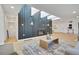 Modern living room with a fireplace, skylights, and wood-paneled accent wall at 456 Cherry St, Denver, CO 80220