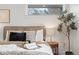 Close up of decorated bed in bright main bedroom, windows and lighting at 456 Cherry St, Denver, CO 80220