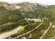 Scenic aerial view of the mountain community with lake and lush greenery at 592 Brook Dr, Idaho Springs, CO 80452
