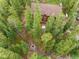 Aerial view of cozy cabin nestled among tall trees, featuring fire pit at 592 Brook Dr, Idaho Springs, CO 80452