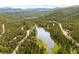 Picturesque aerial view of mountain community showcasing lake and surrounding landscape at 592 Brook Dr, Idaho Springs, CO 80452
