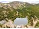 Panoramic aerial shot of mountain lake community surrounded by lush forest at 592 Brook Dr, Idaho Springs, CO 80452