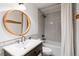 The bathroom features a modern vanity and a beautifully tiled shower-tub combination, providing a clean and stylish space at 592 Brook Dr, Idaho Springs, CO 80452