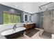 Spa-like bathroom with a freestanding tub, walk-in shower, and a large window with nature views at 592 Brook Dr, Idaho Springs, CO 80452