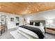 Comfortable bedroom features a wood plank ceiling with an ensuite bathroom and elegant decor at 592 Brook Dr, Idaho Springs, CO 80452