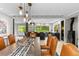 Stunning dining area with modern light fixtures open to a spacious kitchen with a lovely view of the trees at 592 Brook Dr, Idaho Springs, CO 80452