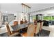 Bright dining area with a long wooden table, leather seating, and seamless access to the kitchen at 592 Brook Dr, Idaho Springs, CO 80452