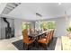 Elegant dining room with a large wooden table, leather chairs, and stylish lighting fixtures at 592 Brook Dr, Idaho Springs, CO 80452