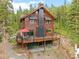 Exterior of wood home with deck and mountain views at 592 Brook Dr, Idaho Springs, CO 80452