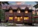 Inviting wood-clad home featuring large windows and a charming entrance, perfect for mountain living at 592 Brook Dr, Idaho Springs, CO 80452