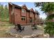 Charming wood-sided home with a quaint stone fire pit area, blending rustic charm with outdoor living at 592 Brook Dr, Idaho Springs, CO 80452