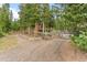 Gated driveway to a wooded mountain home, providing privacy and security at 592 Brook Dr, Idaho Springs, CO 80452