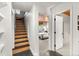 Hallway with stairs and a glimpse into a bedroom, highlighting the home's layout and connection between spaces at 592 Brook Dr, Idaho Springs, CO 80452