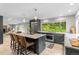 Spacious kitchen with a large island, stainless steel appliances, and a picturesque view of the surrounding greenery at 592 Brook Dr, Idaho Springs, CO 80452