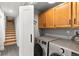 Convenient laundry room with modern washer and dryer units, plus ample storage cabinets at 592 Brook Dr, Idaho Springs, CO 80452