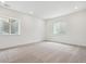 Finished basement with carpet and two bright window wells providing natural light at 8607 Yellowcress St, Littleton, CO 80125