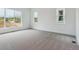 Bright bedroom with plush carpeting and ample natural light from three windows at 8607 Yellowcress St, Littleton, CO 80125