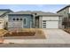 Modern home featuring a two-car garage and contemporary landscaping at 8607 Yellowcress St, Littleton, CO 80125