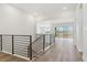 Open-concept hallway with modern railings and bright white walls at 8607 Yellowcress St, Littleton, CO 80125