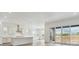 Bright, modern kitchen with sleek white cabinets and a large island at 8607 Yellowcress St, Littleton, CO 80125