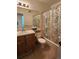 Bathroom with a large mirror, vanity sink, and patterned shower curtain at 8335 Fairmount Dr # 8-206, Denver, CO 80247