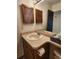 Bathroom with a large mirror and sink vanity with brown wooden shutters at 8335 Fairmount Dr # 8-206, Denver, CO 80247