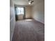 The bedroom has a large window for great light and neutral carpet at 8335 Fairmount Dr # 8-206, Denver, CO 80247
