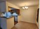 Cozy dining area with a stylish chandelier and easy access to the kitchen at 8335 Fairmount Dr # 8-206, Denver, CO 80247