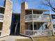 Attractive condo featuring an entryway with stone accents and double balconies at 8335 Fairmount Dr # 8-206, Denver, CO 80247
