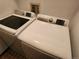 Modern white Samsung washer and dryer set sit in laundry room at 8335 Fairmount Dr # 8-206, Denver, CO 80247