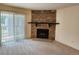 Inviting living room featuring a striking stone fireplace and sliding glass door at 8335 Fairmount Dr # 8-206, Denver, CO 80247