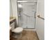 This bathroom features a walk-in shower with clear sliding glass door at 8335 Fairmount Dr # 8-206, Denver, CO 80247