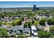 Scenic aerial view of a neighborhood surrounded by lush trees and city skyline at 1065 S Monroe St, Denver, CO 80209